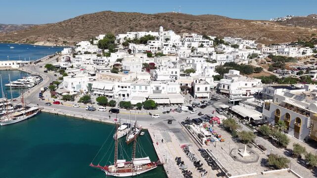 Aerial view of Adamantas port and traditional waterfront town in Milos island, Greece