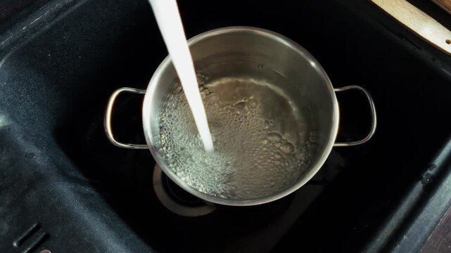 Pouring Tap Water Into Metal Pot. Liquid Stream Filling Stainless Steel Saucepan. Cooking Preparation 