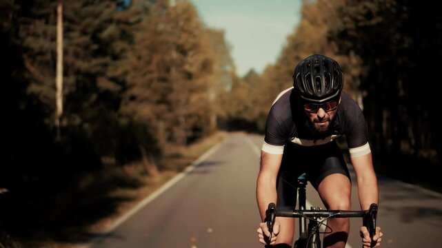 Cyclist Riding Road Bicycle On Asphalt Highway.
Fast Cycling. Triathlon Training