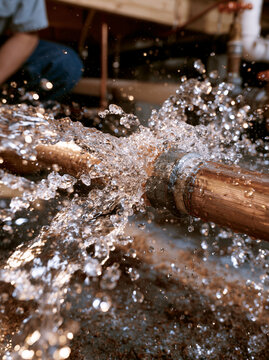 Burst Household Water Pipe Spraying Water During Emergency Plumbing Repair
