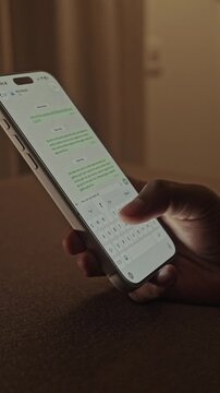 Man hands chatting and typing on smartphone macro closeup. Unrecognizable human typing text message tapping touchscreen keyboard using whatsapp application a social media