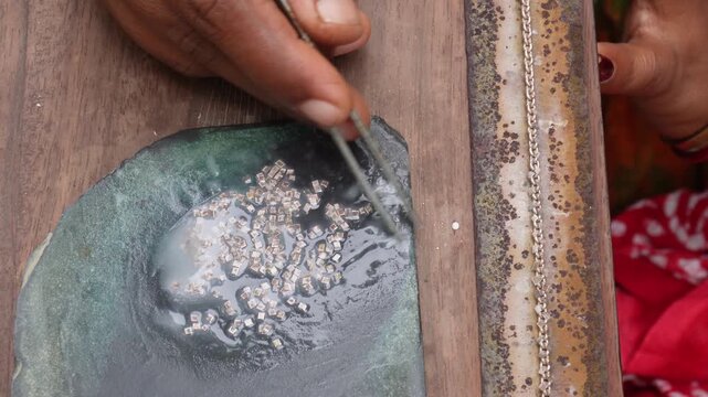 Goldsmith crafting fine jewelry with precision and focus