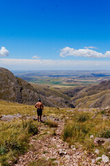 Obraz premium Hiker overlooking a semiarid valley