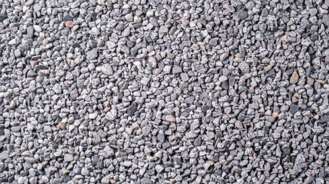 Gray gravel texture background. Macro shot of small crushed stones for construction.