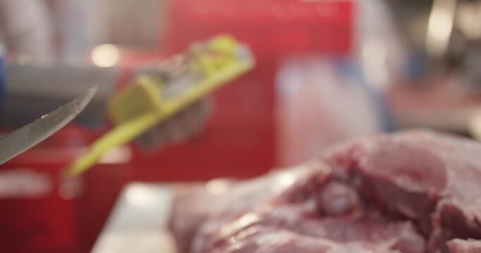 Gloved hand reaches for a knife in a yellow holder