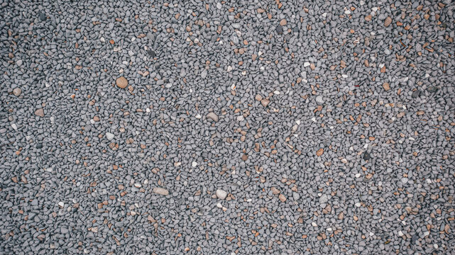 Gray gravel texture background. Top down view of small crushed stone surface.