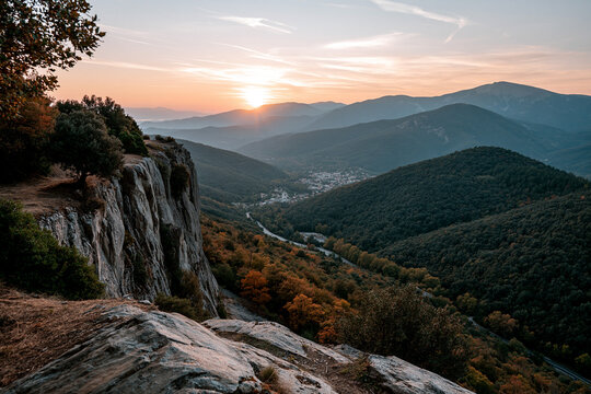 Sunset over hills and valley near small town