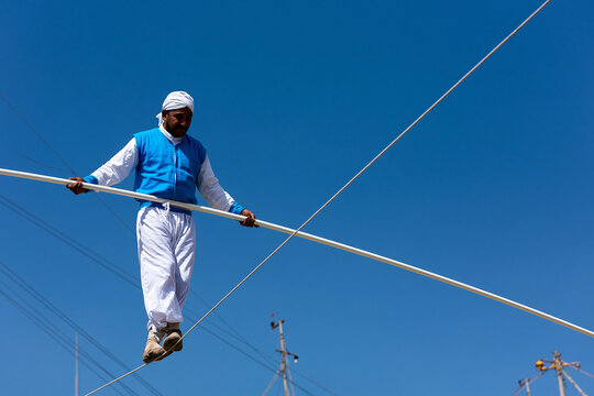 Tightrope walker performs high above the ground
