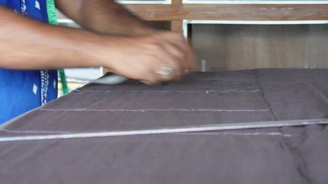 Tailor cutting fabric for garment making