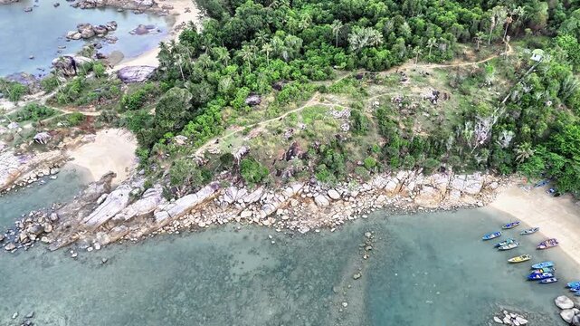 Aerial Cinematic Landscape of Turun Aban Beach Bangka with Rocky Granite Coastline, Clear Tropical Sea and Peaceful Island Scenery from Above