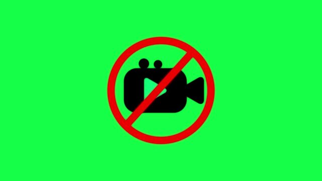 A black camera inside a red prohibition circle on a bright green background indicating that filming or recording is not allowed here