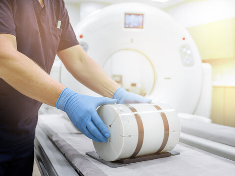 Radiographer positioning CT phantom for quality assurance