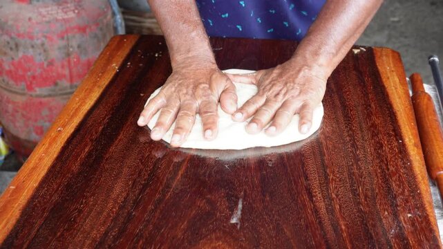 Rumali roti preparation with skilled traditional cooking