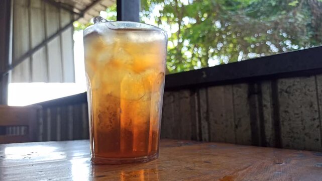A glass of refreshing iced tea served on a hot afternoon, offering a cool and revitalizing drink perfect for relaxing in warm tropical weather.