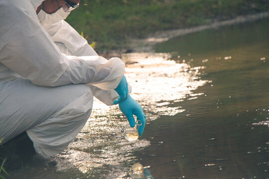 Environmental technician measuring water quality for pollution prevention.