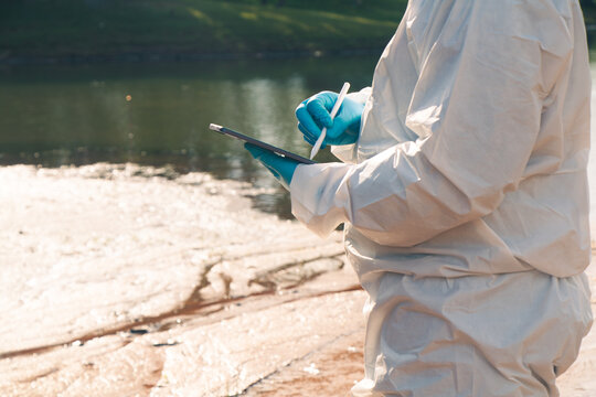 Experts conduct water quality checks and analysis to record data on tablets.
