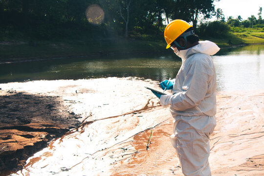 Experts conduct water quality checks and analysis to record data on tablets.