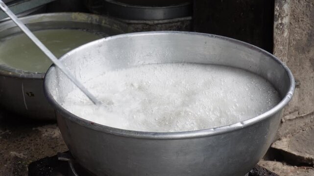 Sugar syrup boiling in large pot for sweet making