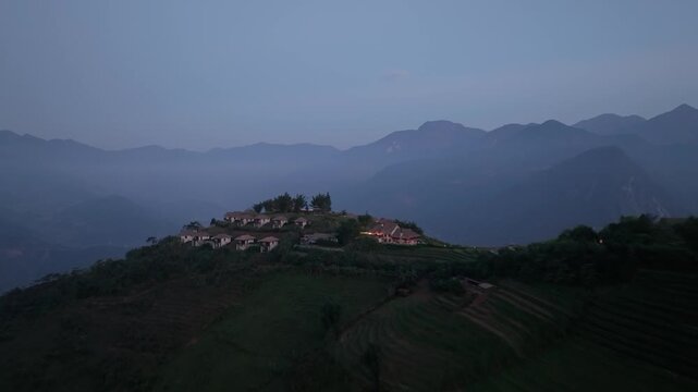 Mountain resort overlooking terraced rice fields and misty Hoang Lien Son mountains in Sa Pa, Vietnam