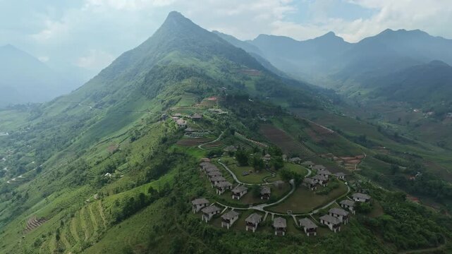 Aerial view of mountain resort in Sa Pa amid terraced valleys and Hoang Lien Son peaks