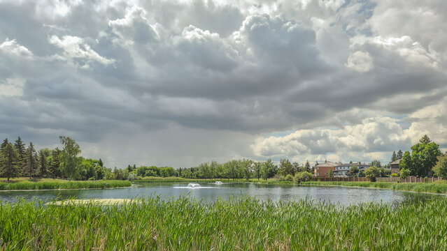 Storm clouds gathering above Lakeview Pond in Saskatoon, Canada
