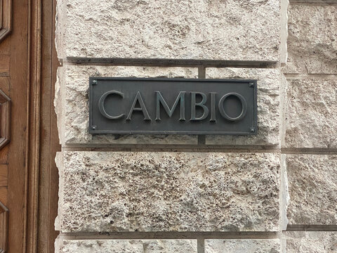 Cambio sign presenting concepts of change, currency exchange, and evolution on a stone facade in Cremona, Italy
