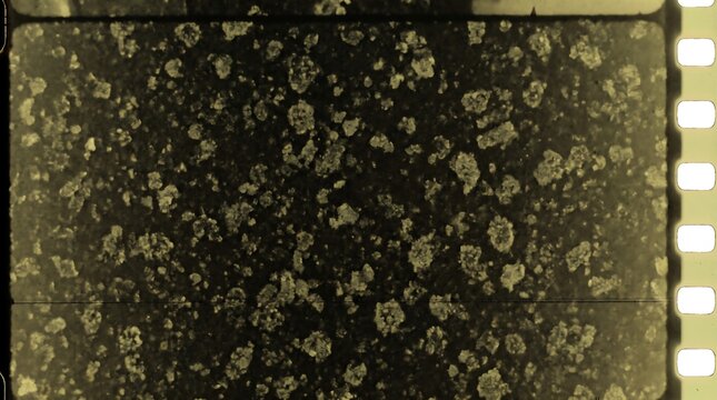 Vintage sepia film strip texture with heavy grain and dust marks showing classic movie aesthetic