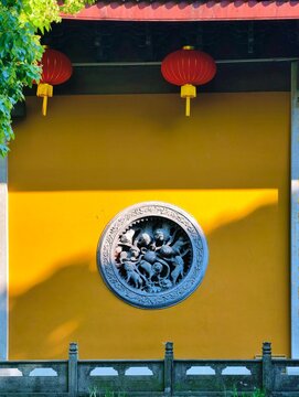 The yellow wall relief, characteristic East Asian architecture of an old temple (Faxi Temple, Hangzhou, China)