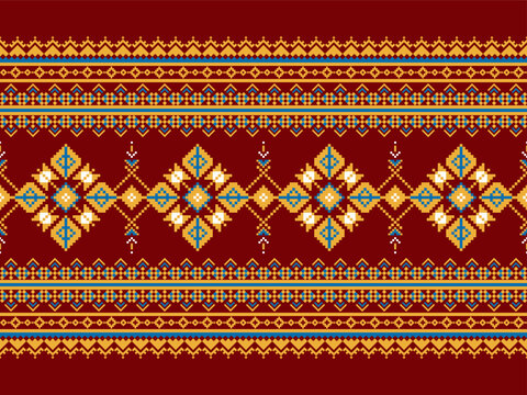Seamless pixel textile pattern featuring geometric floral medallions, ornamental borders, and a symmetrical horizontal layout in red, orange, blue, and white tones for surface design.