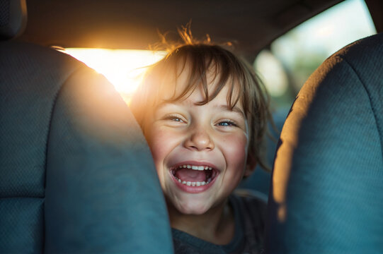 Child laughing joyfully from the back seat of a car