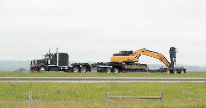 Heavy Cargo on the  Road. A truck hauling freight along a highway. Talen near Airdrie, Alberta, Canada
