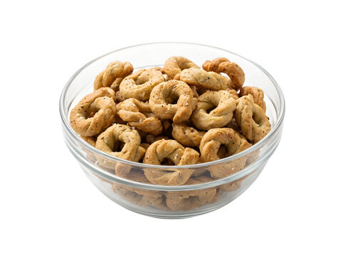 Small round crispy taralli snacks in a clear glass bowl isolated on transparent background
