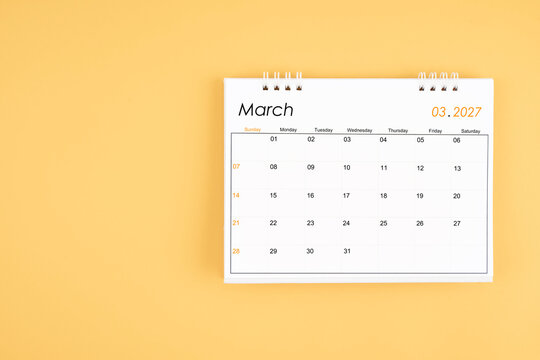 March 2027 desk calendar on yellow color background, position with copy space.