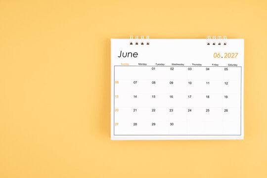 June 2027 desk calendar on yellow color background, position with copy space.