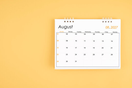 August 2027 desk calendar on yellow color background, position with copy space.