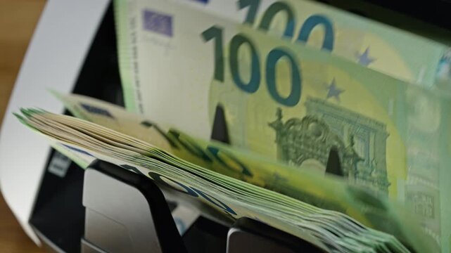 Automatic counting of euro banknotes during lending and loan approval procedures. Banking, mortgage financing, credit services and financial support concept.