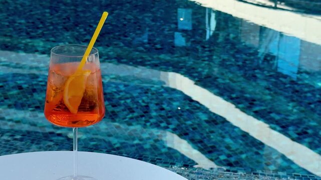  Orange spritz on white poolside table &mdash; turquoise mosaic tiles and sunlit ripples