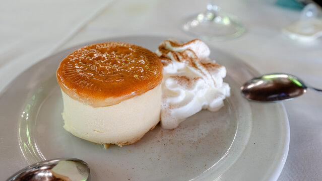 Cheesecake dessert with biscuit and cream topping