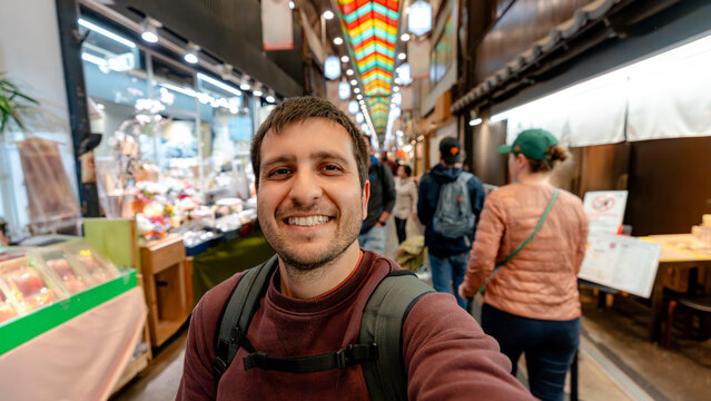 Man exploring Nishiki Market in Kyoto, Japan