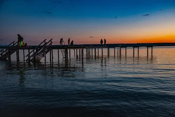 Stegspaziergang auf dem Ammersee, Sonnenuntergang am Ammersee in Bayern © photo-corona