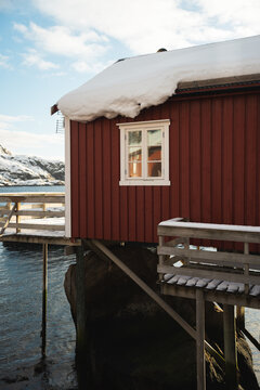 Traditional red cabin on snowy Lofoten Islands