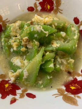 The Thai dish is called "Pad Bua Sai Kai" (stir-fried zucchini with eggs).
