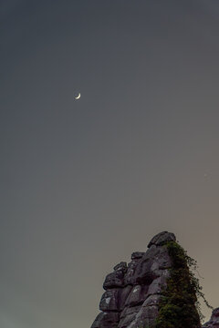 Crescent moon above rocky formations in Torcal de Antequera