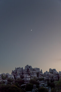 Majestic limestone formations under crescent moon