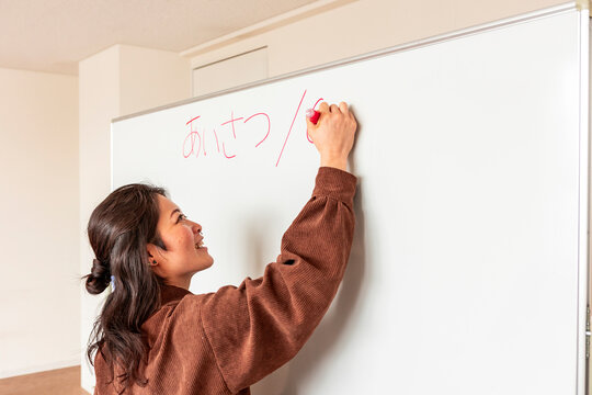 Adult Japanese lesson with teacher writing hiragana