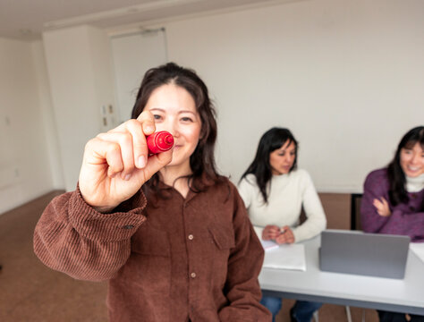 Adult Japanese language lesson in classroom with teacher