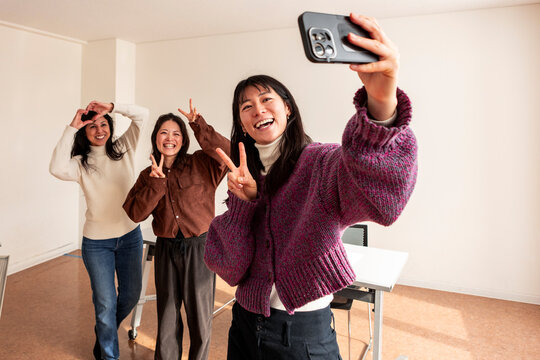 Adult Japanese lesson students taking a classroom selfie