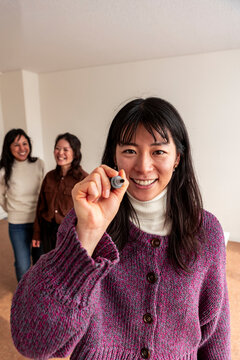 Smiling Japanese teacher holding marker in adult class