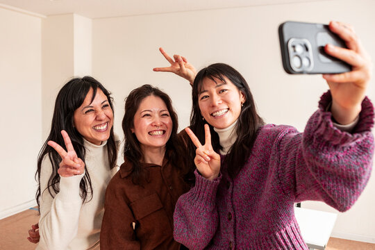 Adult Japanese lesson group taking a cheerful selfie
