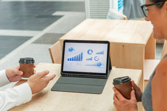 Business meeting with tablet analytics and coffee cups
